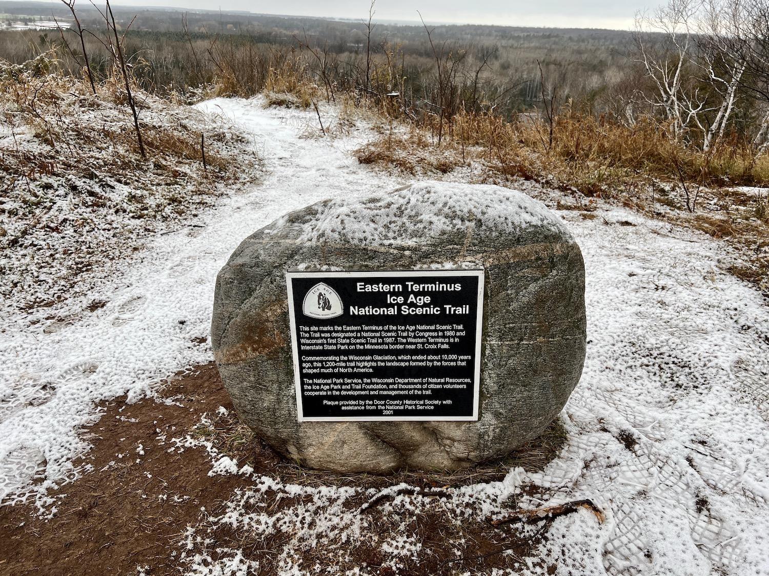 The eastern terminus of the Ice Age National Scenic Trail is marked by this rock and plaque in Potawatomi State Park.
