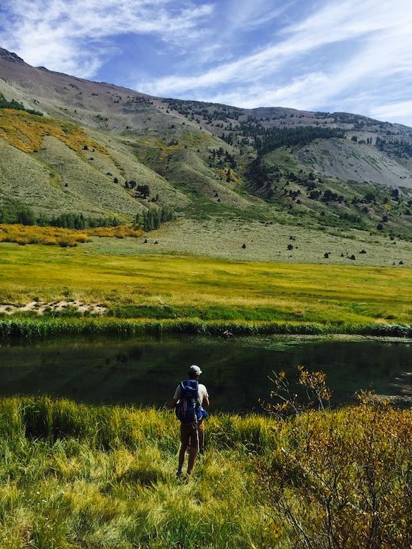 Man fishing near alpine lake