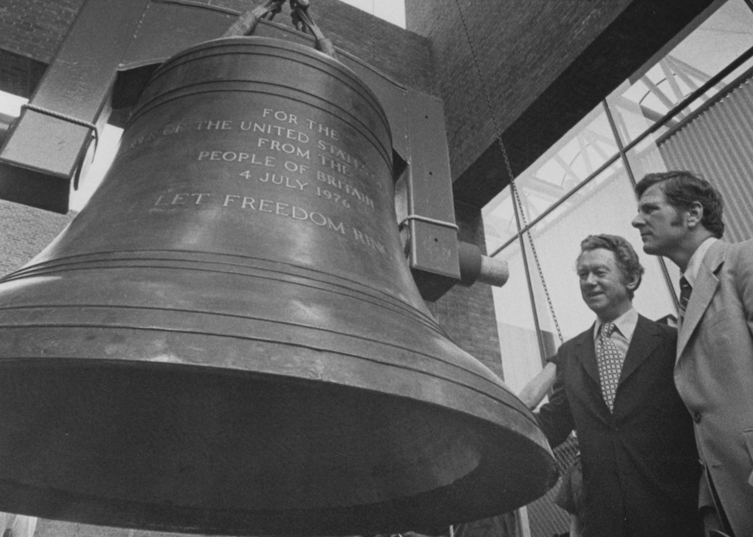 A June 1976 file photo shows the Bicentennial Bell being hoisted to its new home in the Independence National Historical Park visitor center as British Consul General Denis Richards and park Superintendent Hobart Cawood look on.