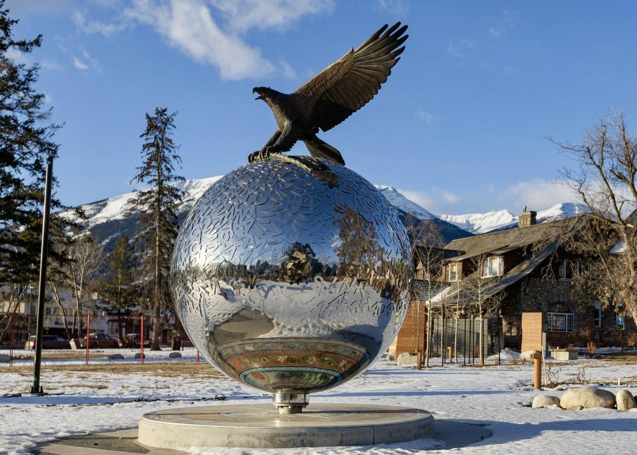 The focal point at the center of the Jasper Indigenous Exhibit — a collaborative Indigenous art installation — features a large bronze sculpture of an eagle resting on a sphere with words from six Indigenous language. 