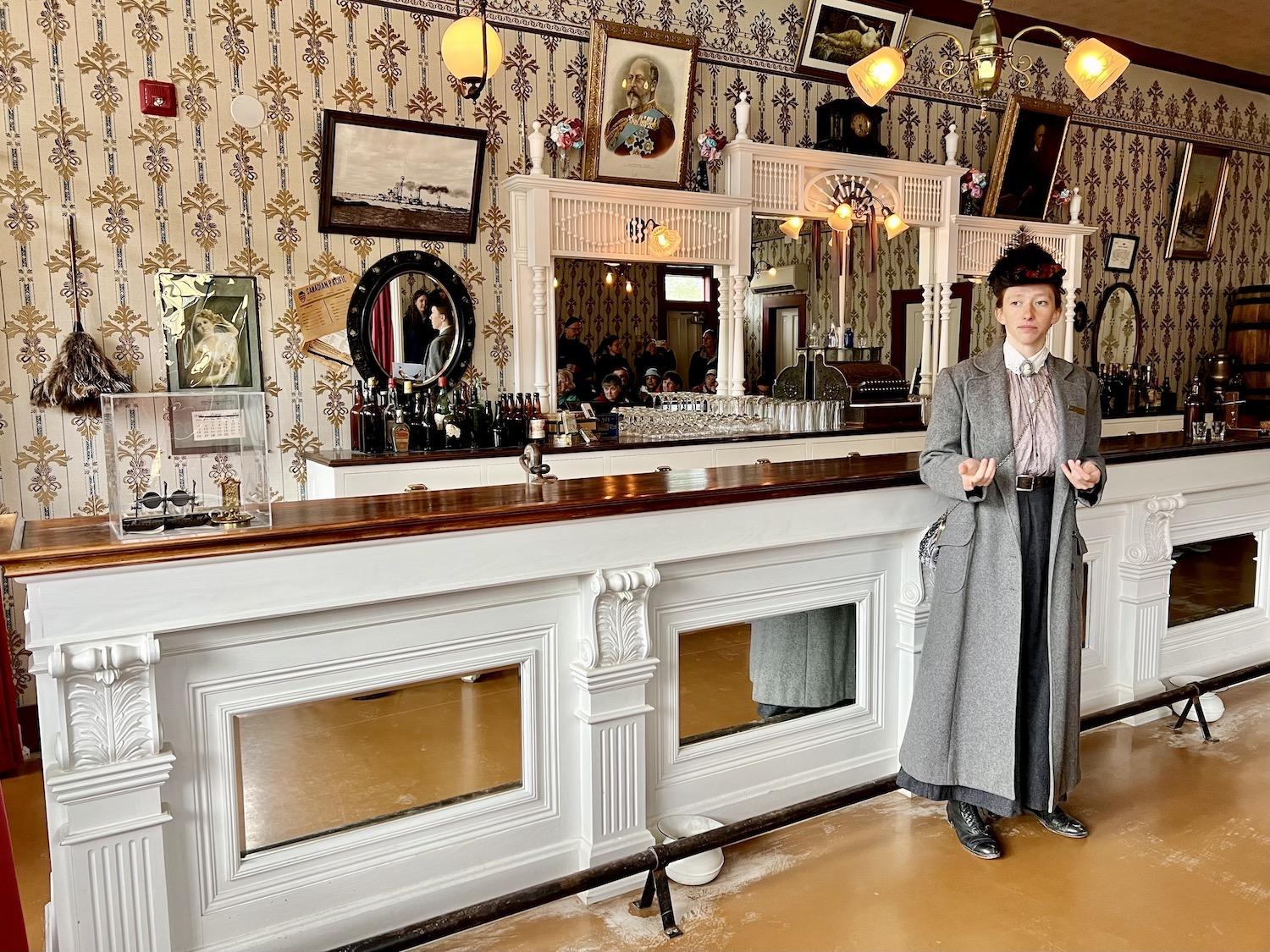 Dressed in period costume, Parks Canada heritage interpreter Miriam Behman leads a tour through buildings that form the Dawson Historical Complex National Historic Site.