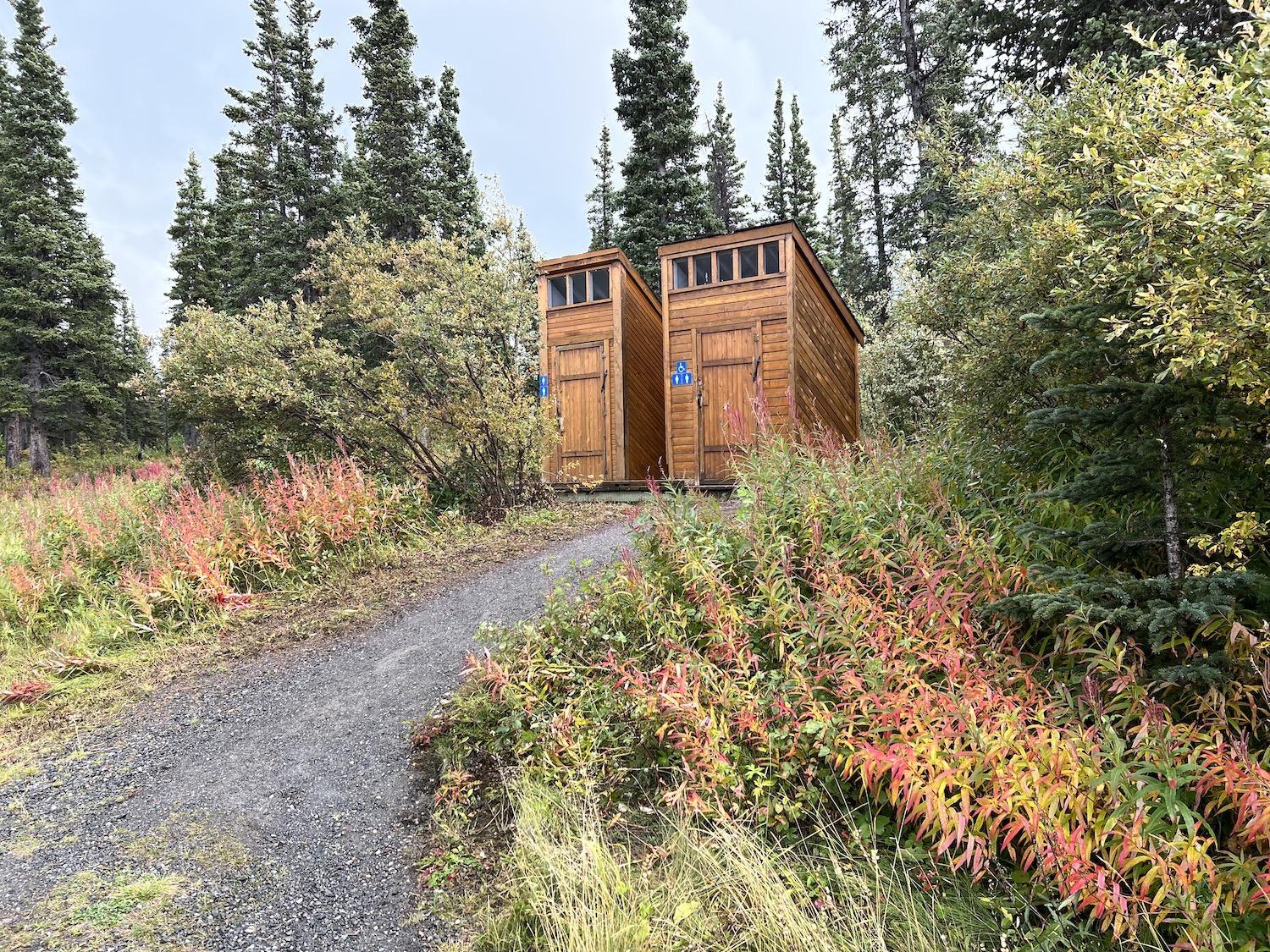 Gorgeous fall foliage surrounds the outhouses at Kathleen Lake at Kluane National Park and Reserve.