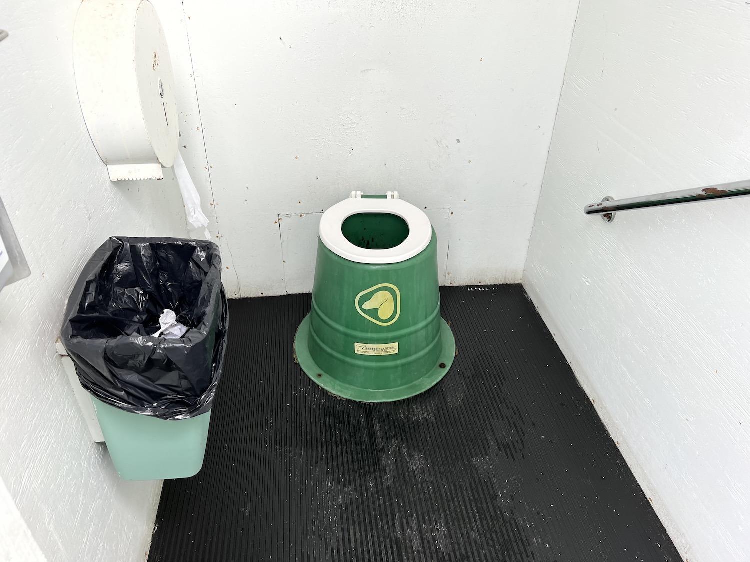 An old Parks Canada branded toilet in an outhouse at Kathleen Lake in Kluane National Park and Reserve.
