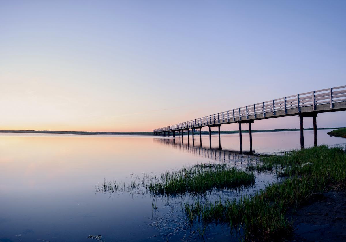 A boardwalk over the ocean to barrier islands.
