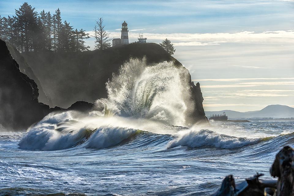 A ship on the river and waves on the cliff, Cape Disappointment State Park, Louis and Clark National Historic Trail / Rebecca Latson