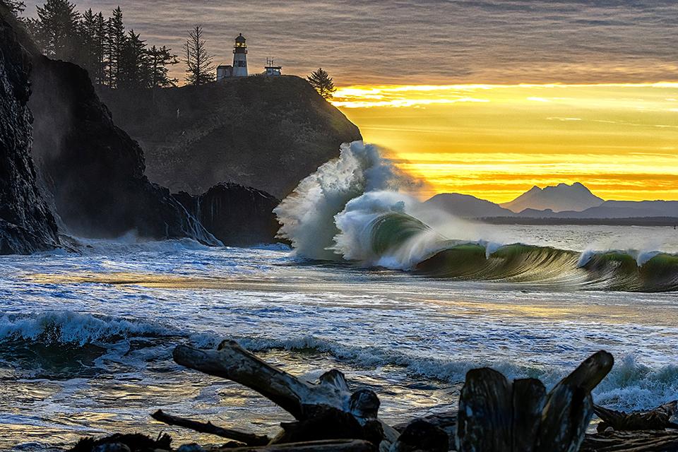 Sunrise and crashing king tide waves at Cape Disappointment, Lewis and Clark National Historic Trail /  Rebecca Latson