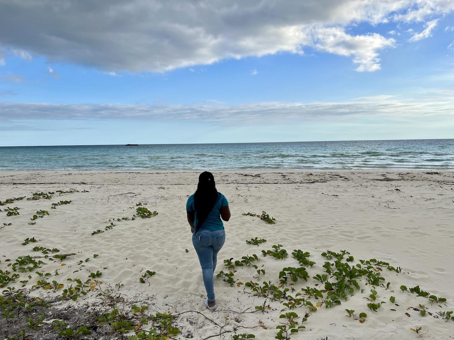 Gabrielle Moxey, of the Bahamas Ministry of Tourism, shows off Gold Rock Beach at Lucayan National Park.