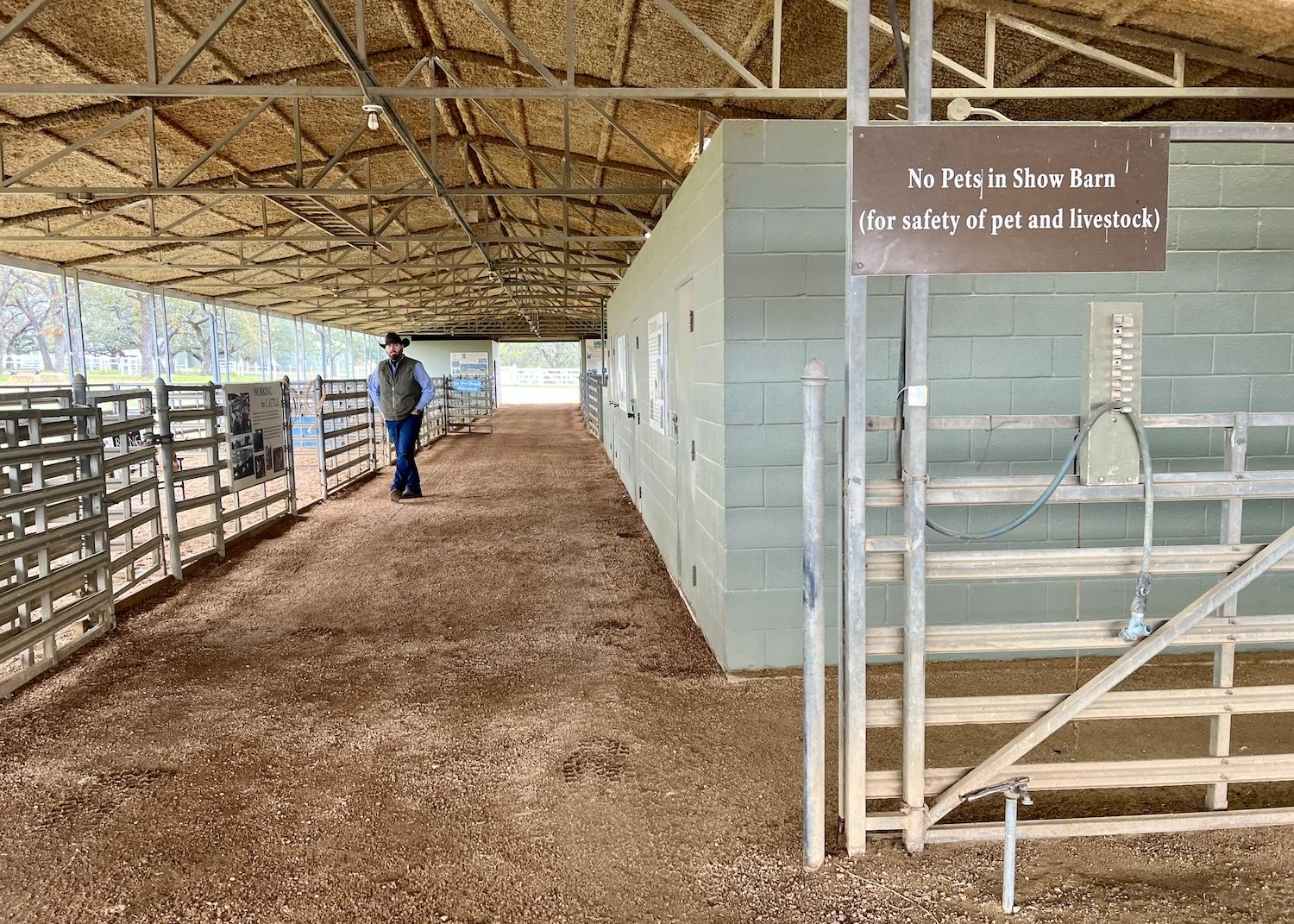 Clint Herriman, LBJ Ranch foreman for the NPS, walks in the Show Barn at Lyndon B. Johnson National Historical Park.