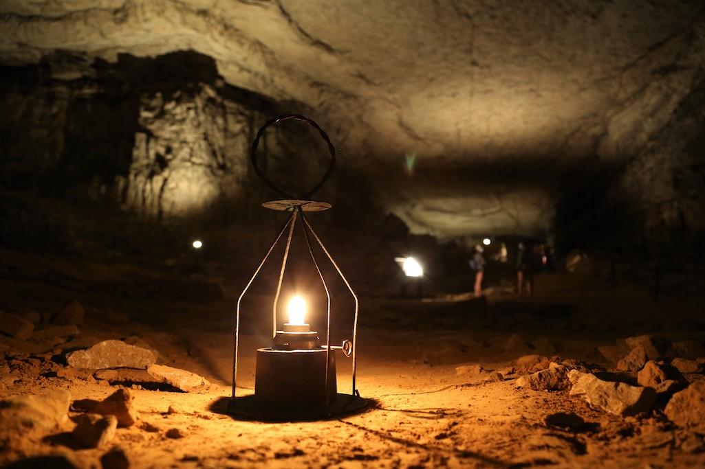 A lantern glows inside Mammoth Cave's Rafinesque Hall. NPS Photo