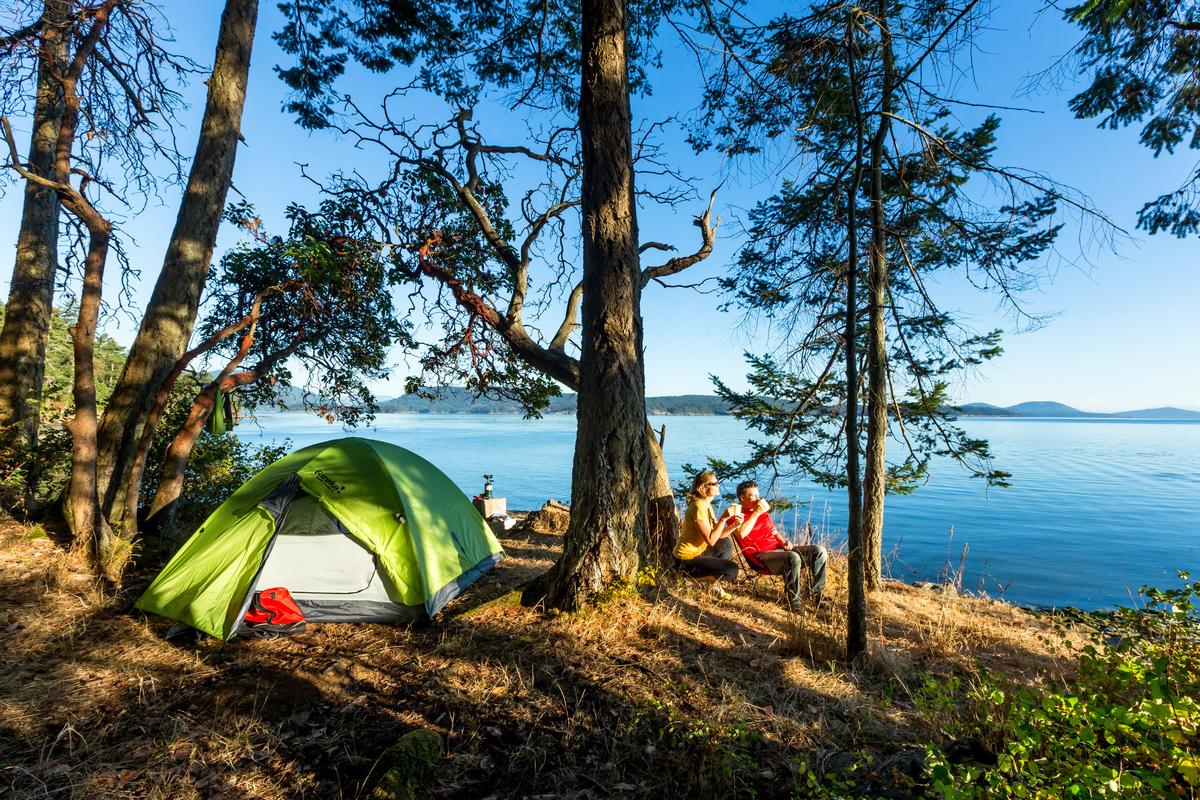 People tent by a lake in one of Parks Canada's protected sites.