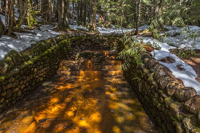 A rocked-in mineral spring along Trail of the Shadows, Mount Rainier National Park / Rebecca Latson