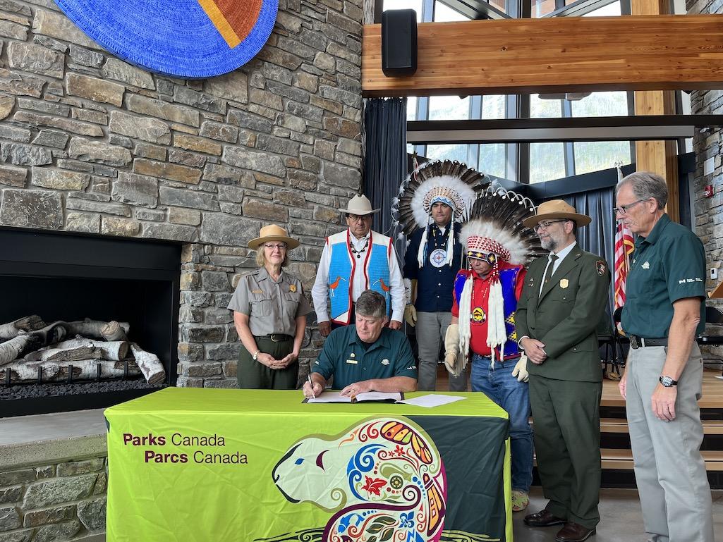 From left to right: Kate Hammond, intermountain regional director, NPS; Chief Roy Fox of Kainai Nation; Ron Hallman (seated), Parks Canada CEO; Council member Samuel Crowfoot of Siksika Nation; Chief Ouray Crowfoot of Siksika Nation; Superintendent Dave R