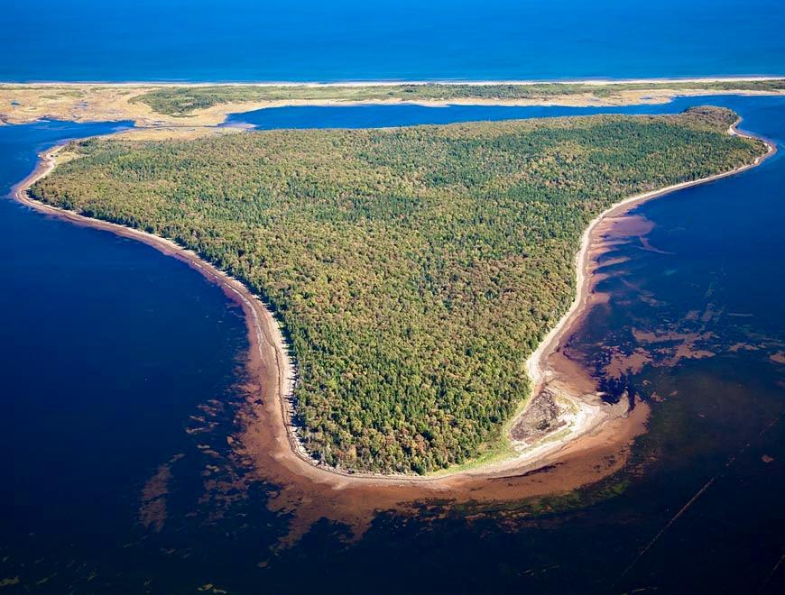An aerial view of the sandhills with the islands of Pituamkek behind them.