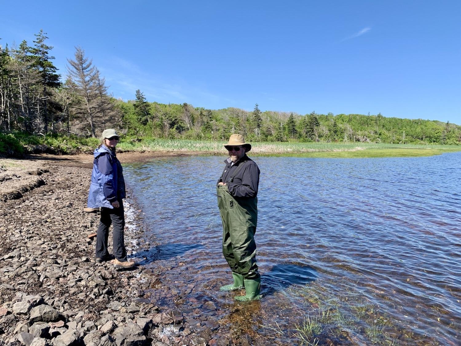Archaeologist Helen Kristmanson and Parks Canada's Luke Arbuckle scour the shore and shallow water for things of interest.