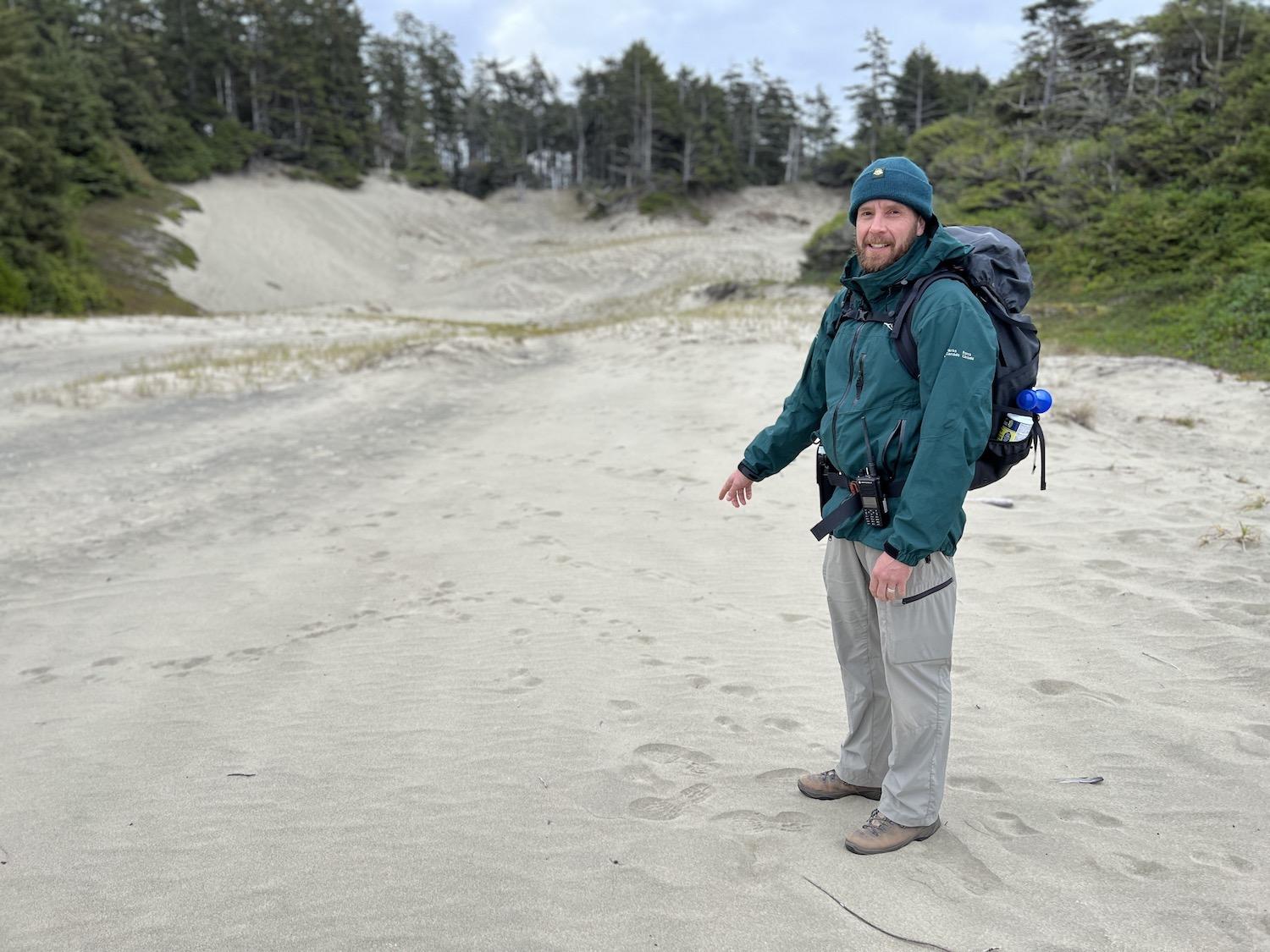 Todd Windle explores the sand dunes of Wickaninnish Beach looking for wolf tracks and scat.