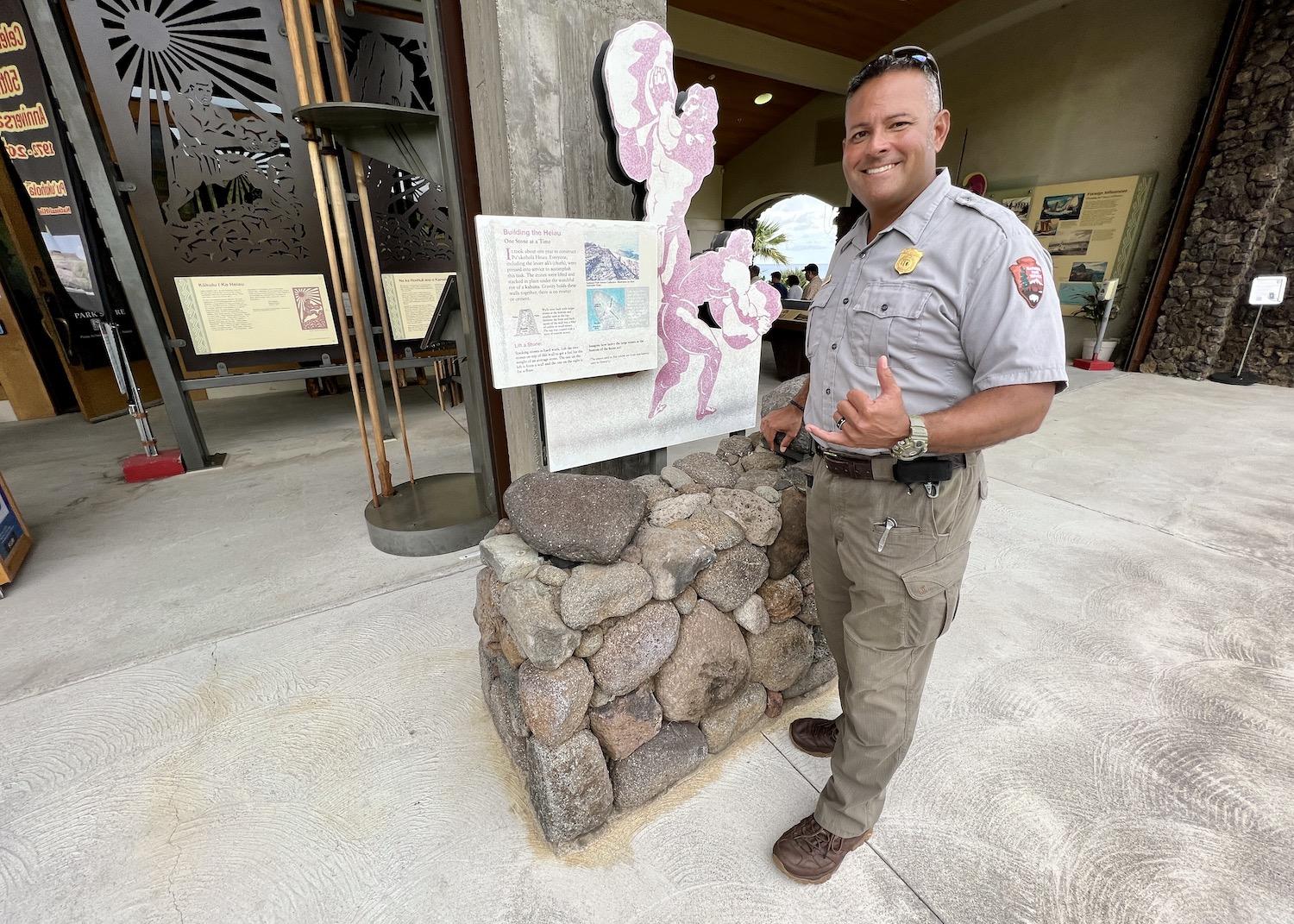 Park ranger George Enuton stands by a rock strength display at the visitor center.