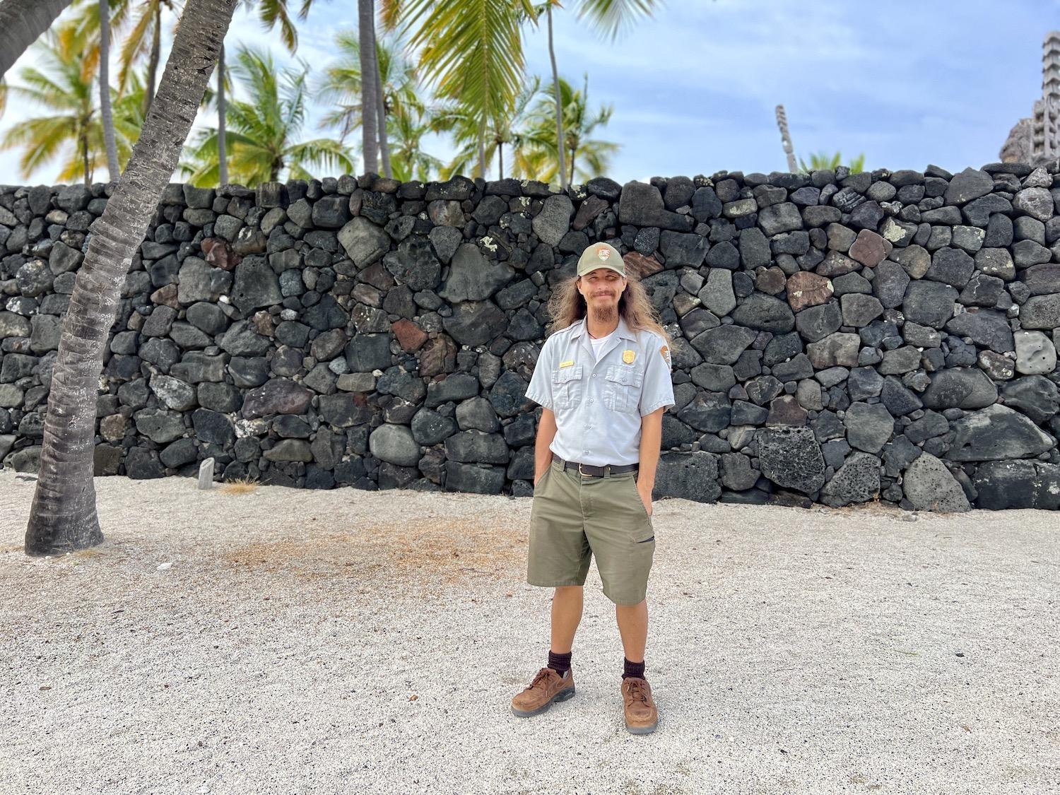 Now in uniform, interpretive ranger Kalā Holiday stands in the Royal Grounds by the Great Wall.