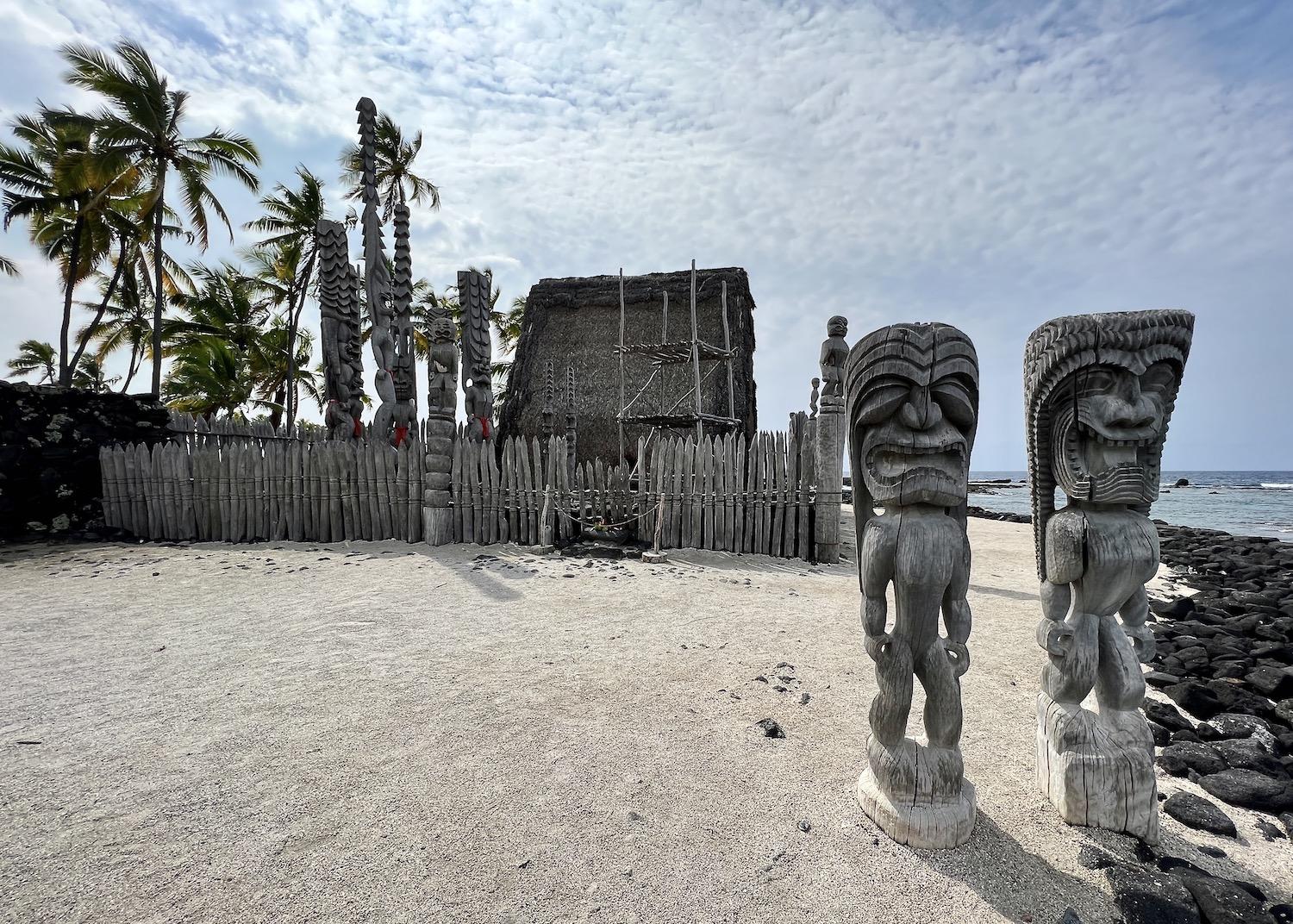 In the Royal Grounds, these two ki'i (wooden images of Hawaiian gods) are considered guardians that stand on shore to alert everyone to the great mana (spiritual power) here.
