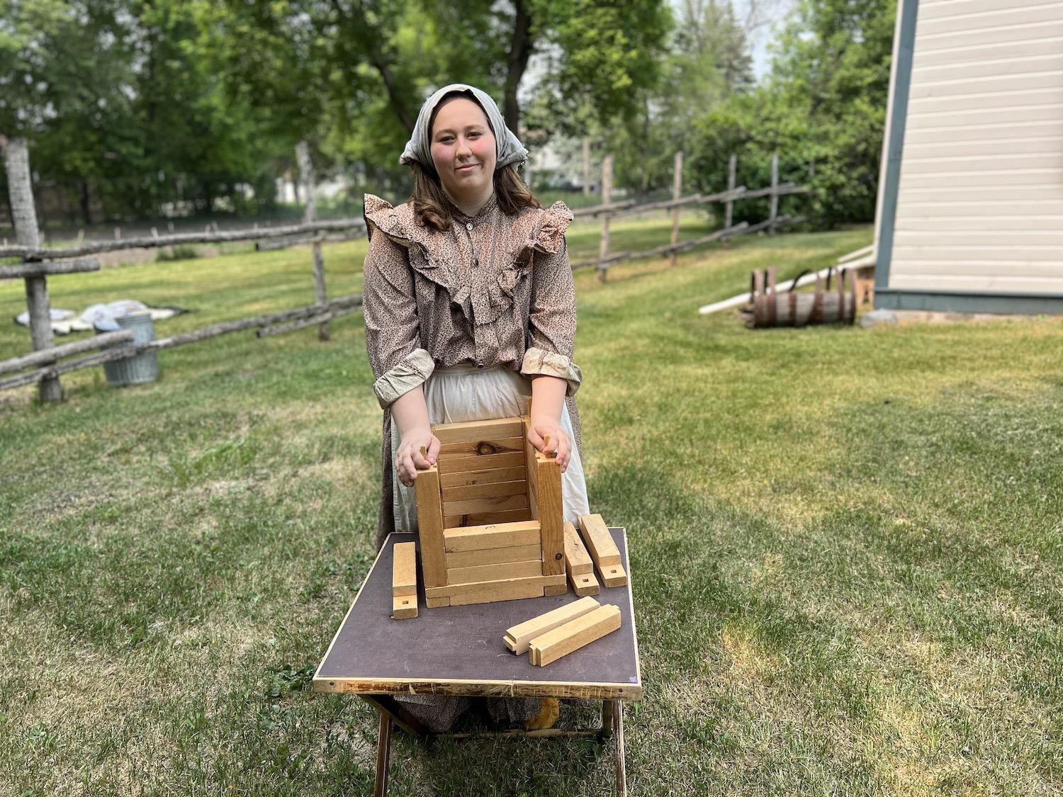 At Riel House National Historic Site, interpreter Gabrielle LaPlume shows how Red River log construction worked.