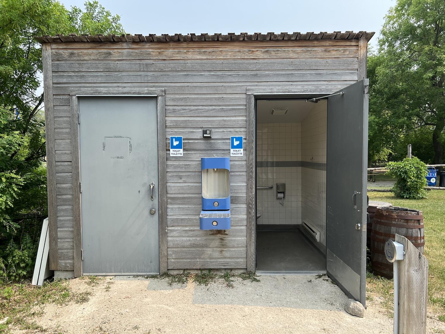 A standalone washroom building with water bottle station at Riel House National Historic Site.
