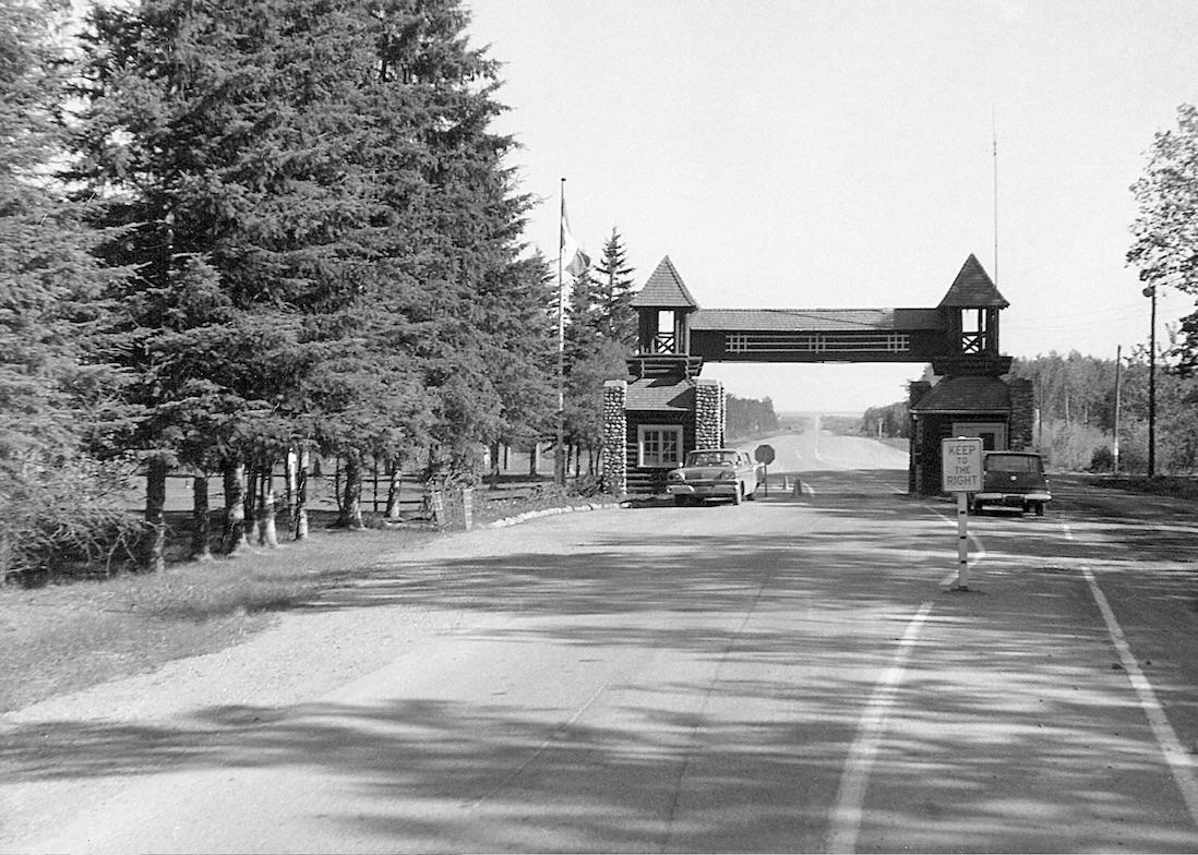 An archival photo of the North Gate of Riding Mountain National Park.