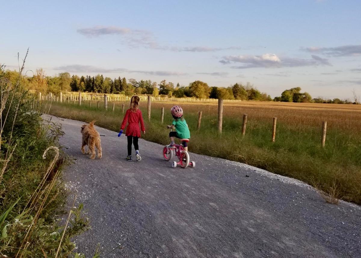 Children bike down a gravel trail in Rouge National Urban Park.