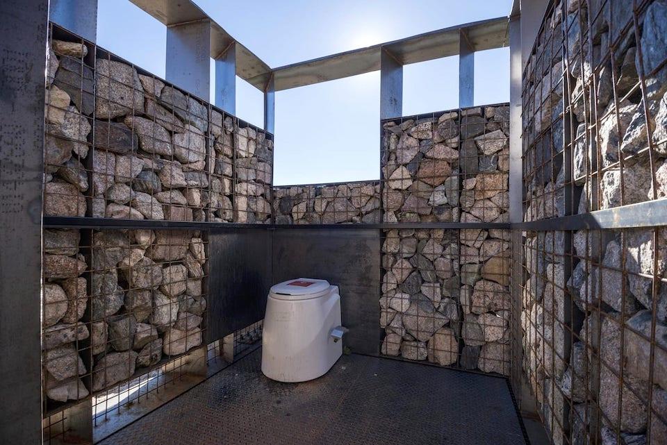 Stone latrine interior, showing closeup of rock design/Jesse Kuroiwa