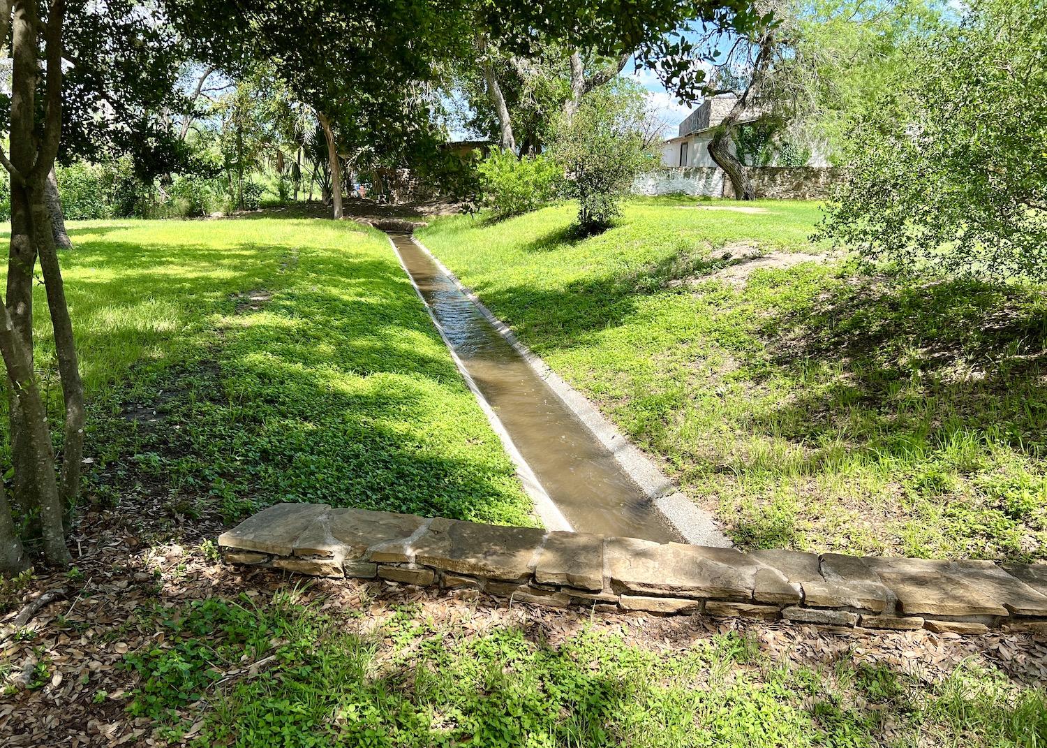 The acequia by the grist mill at Mission San José is now on a closed-pump system.