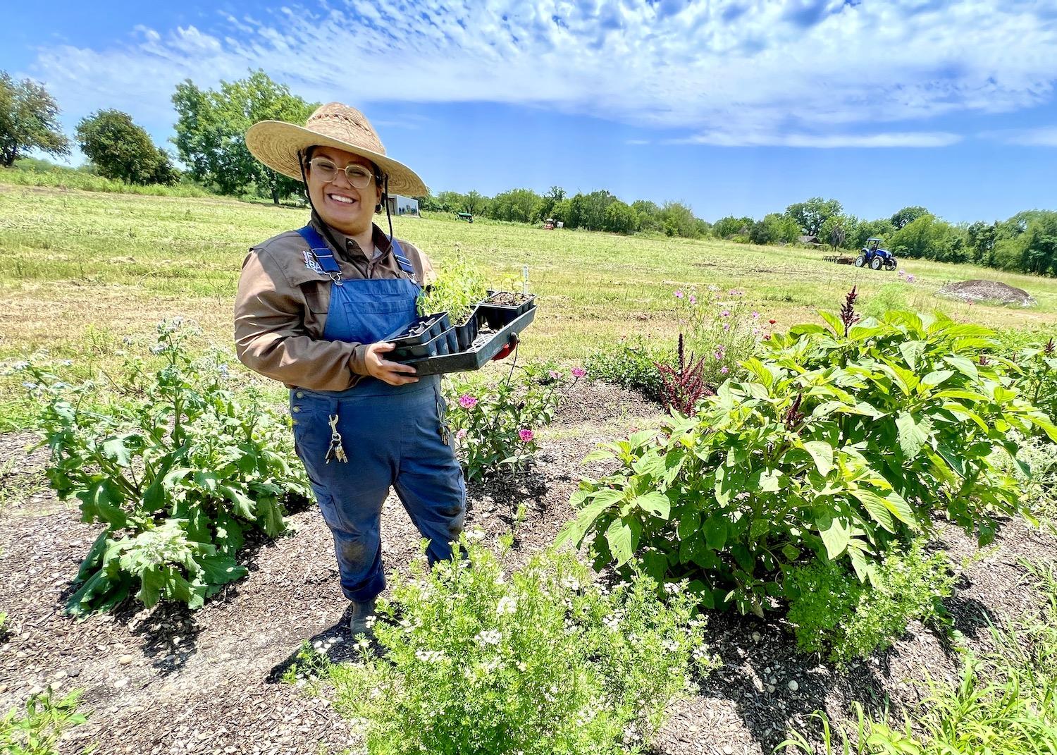 Liliana Reyes, a farm and garden worker with the San Antonio Food Bank, stands in the demonstration field at Mission San Juan.