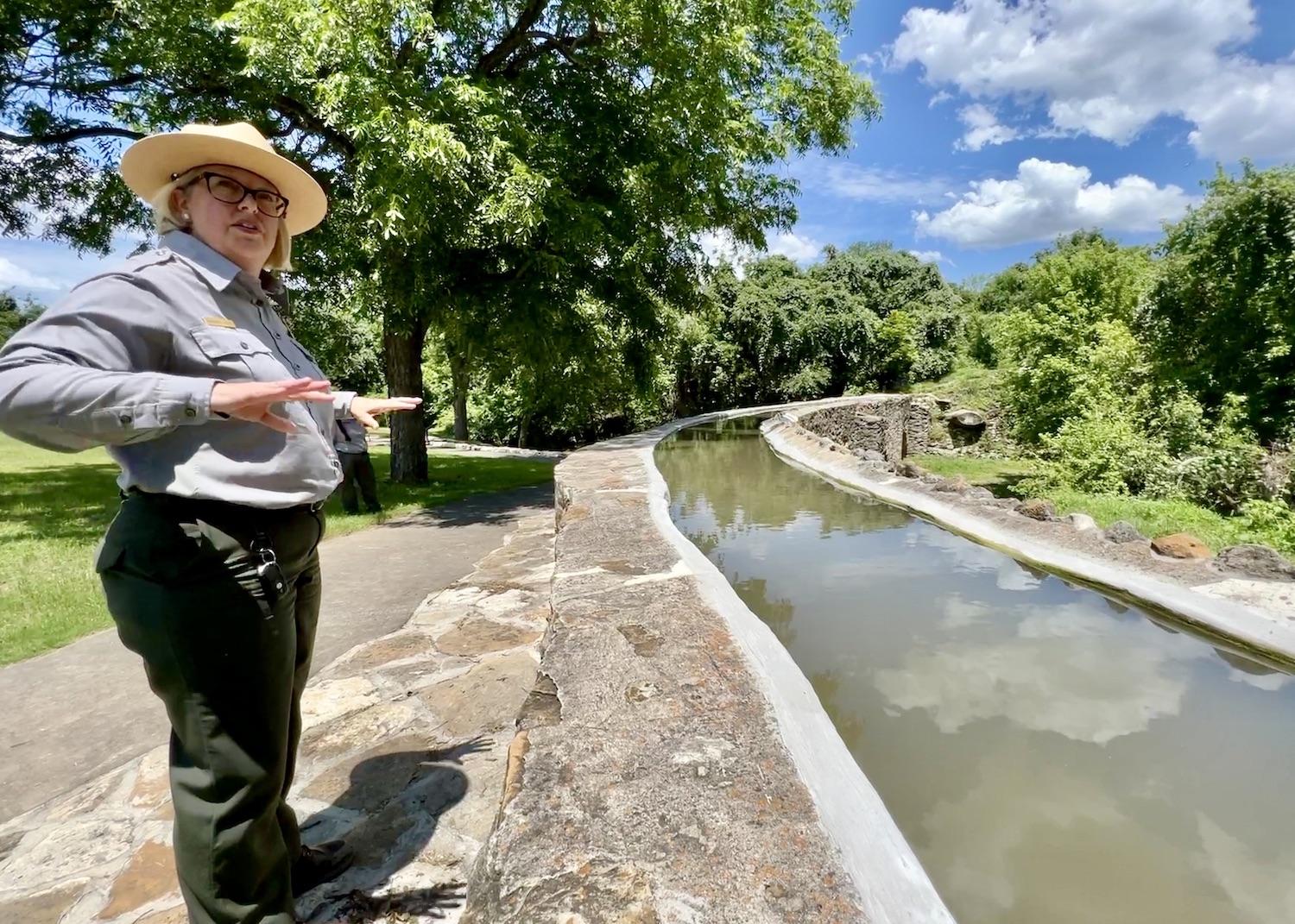 San Antonio Missions Superintendent Christine Jacobs stands at the Espada Aqueduct.