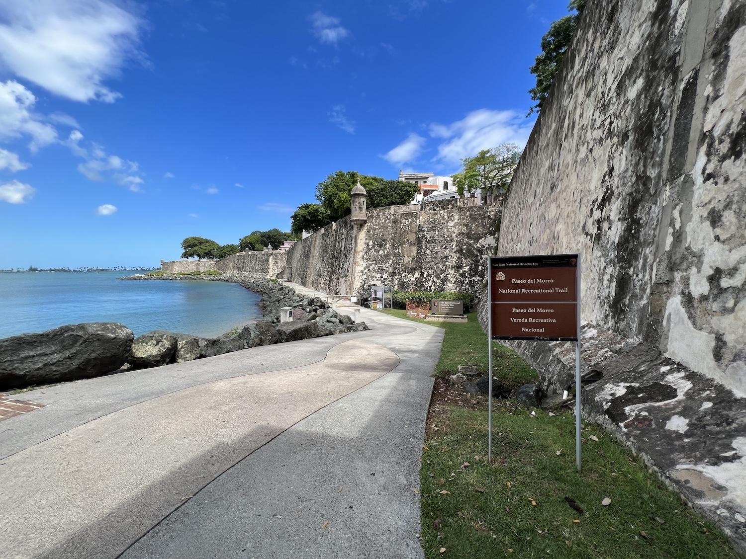 The popular Paseo del Morro paved pathway has been closed for months due to water leaking through the historic walls.