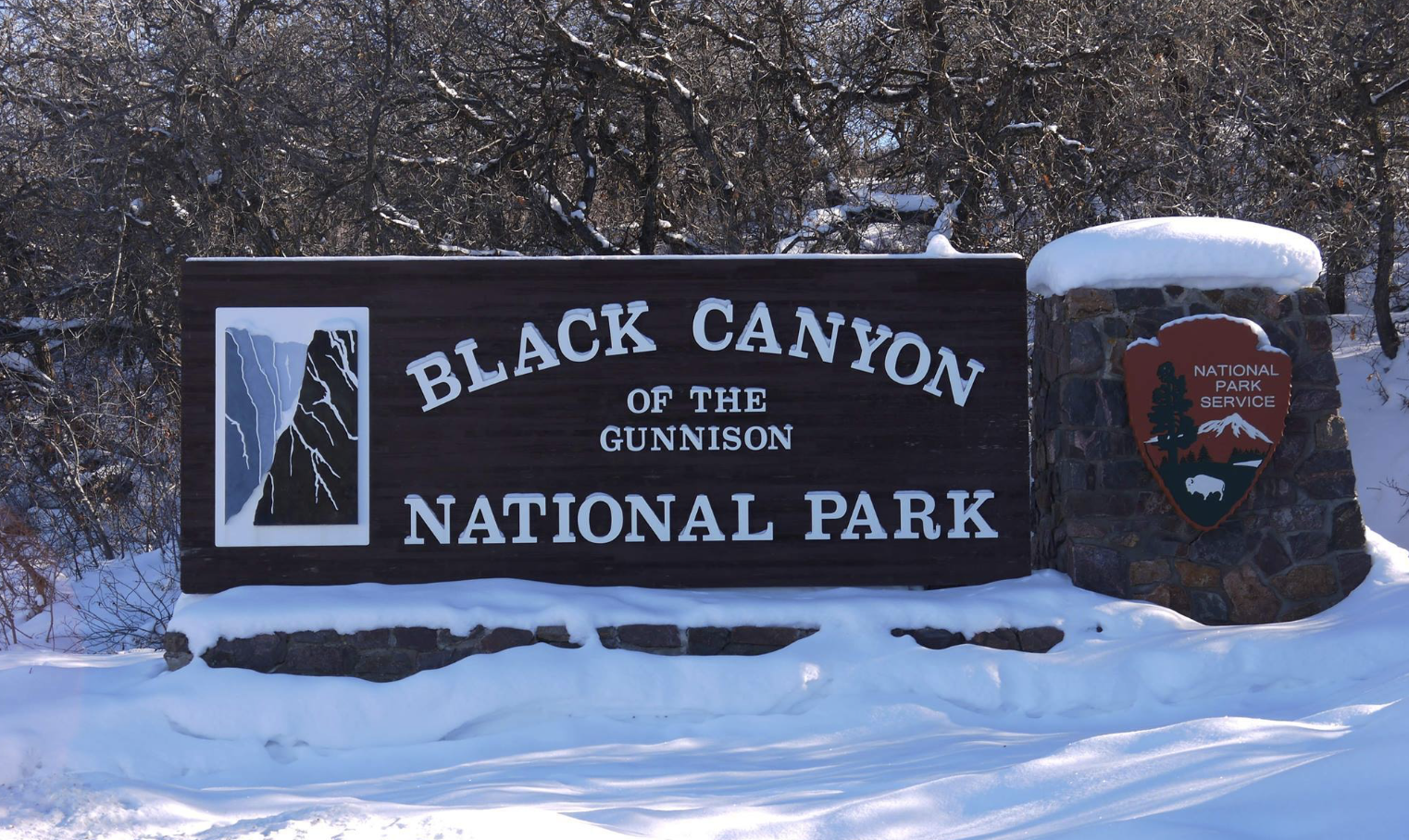 Black Canyon entrance sign in snow / NPS