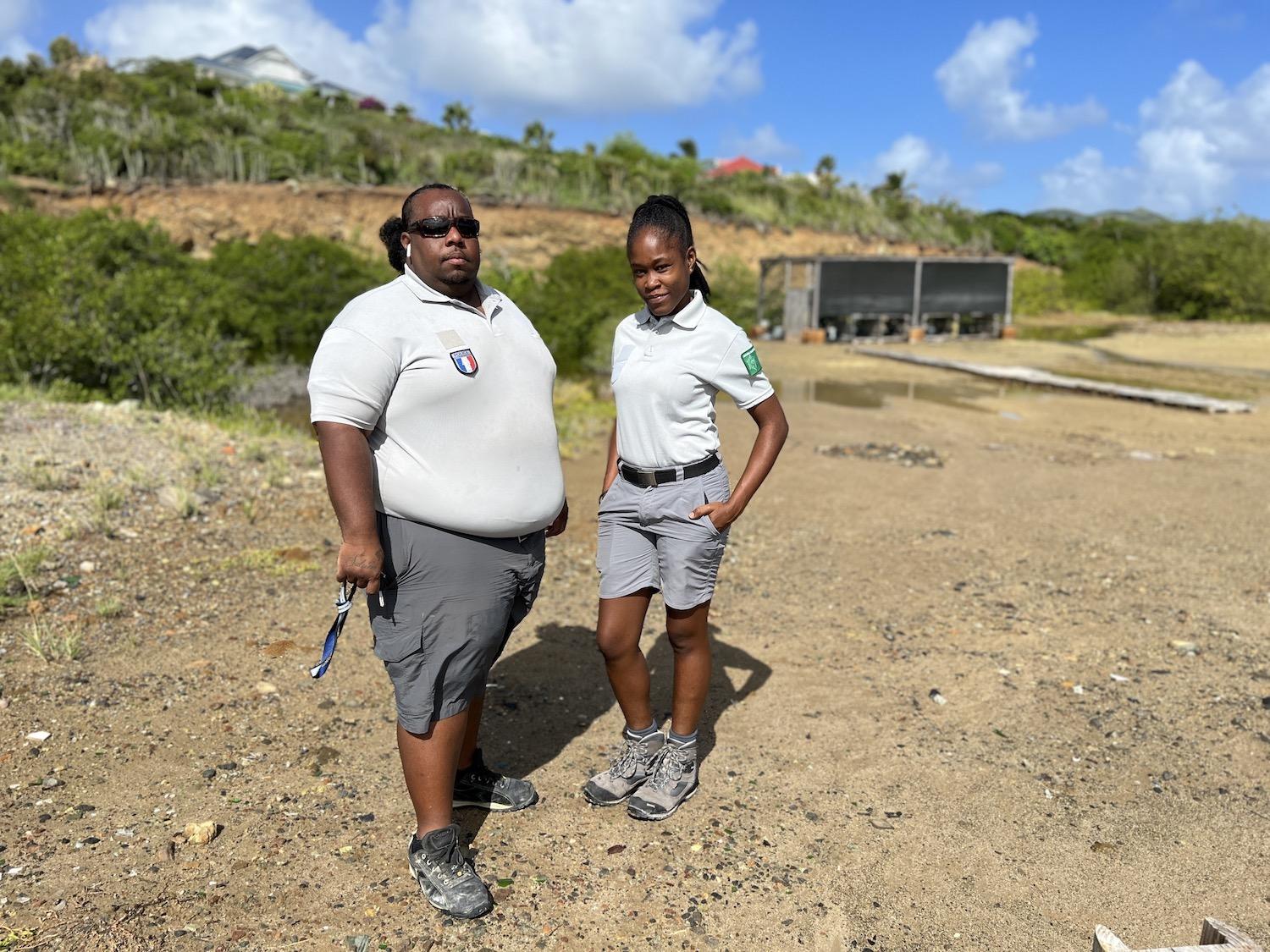 Chris Joé and Ashley Daniel, environmental police officers with the St. Martin Nature Reserve, stand in front of their mangrove nursery on the French side of the Caribbean Island.