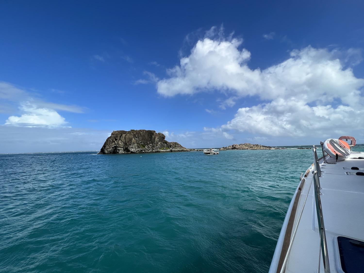 The sea is rough when I sail by Creole Rock with Pyratz Gourmet Sailing. It's popular with divers but protected by the St. Martin Nature Reserve.