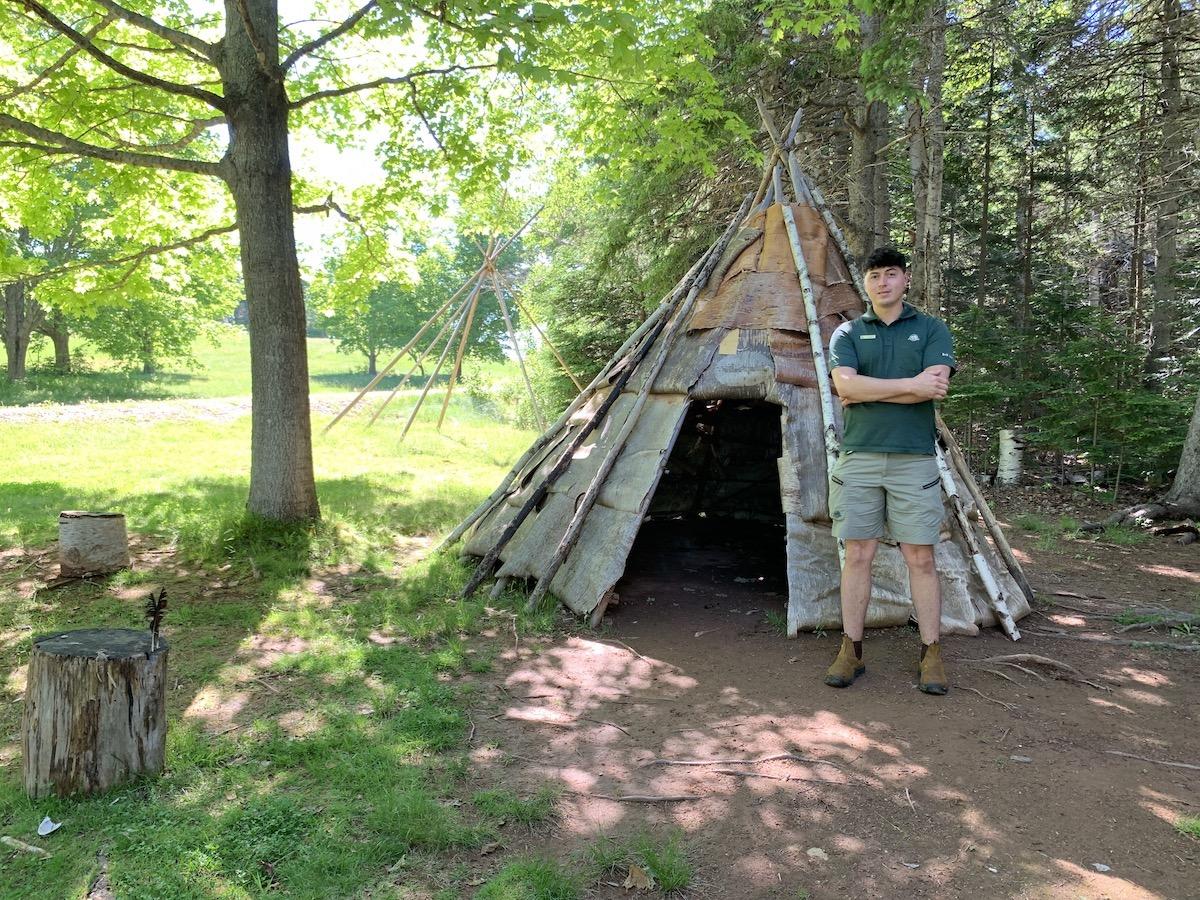 Parks Canada heritage presenter Lucas Milligan shows the wigwams at Skmaqn—Port-la-Joye—Fort Amherst National Historic Site.
