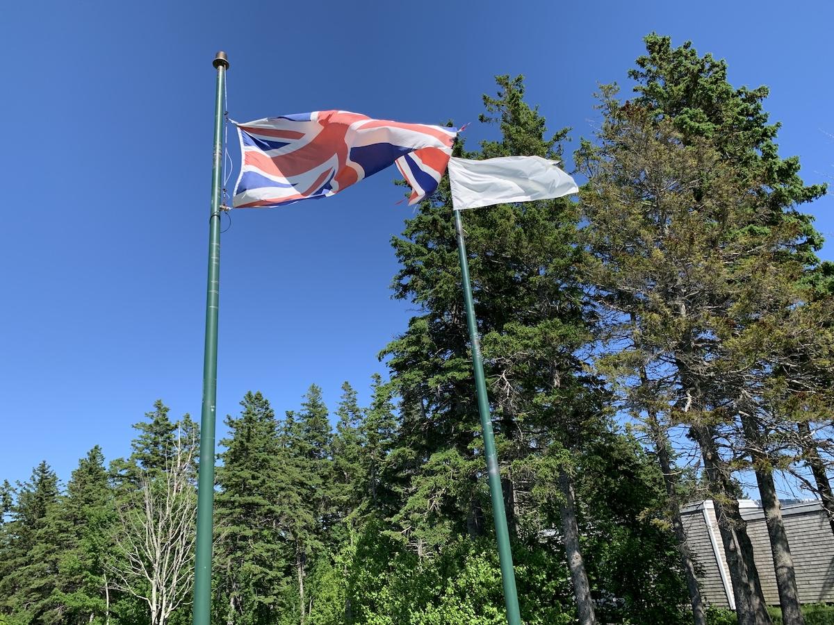 Two flags fly at the national historic site — a British flag and a French naval flag.