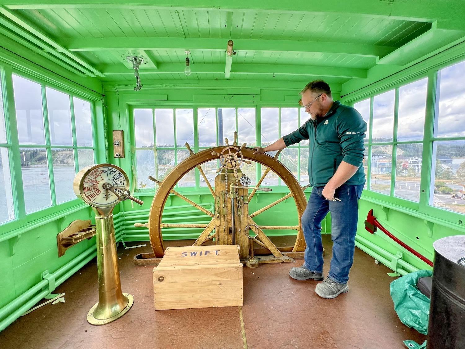 Shipwright Terry Karlsen stands in the S.S. Klondike's wheelhouse, which he hopes people will be able to visit again some day soon.