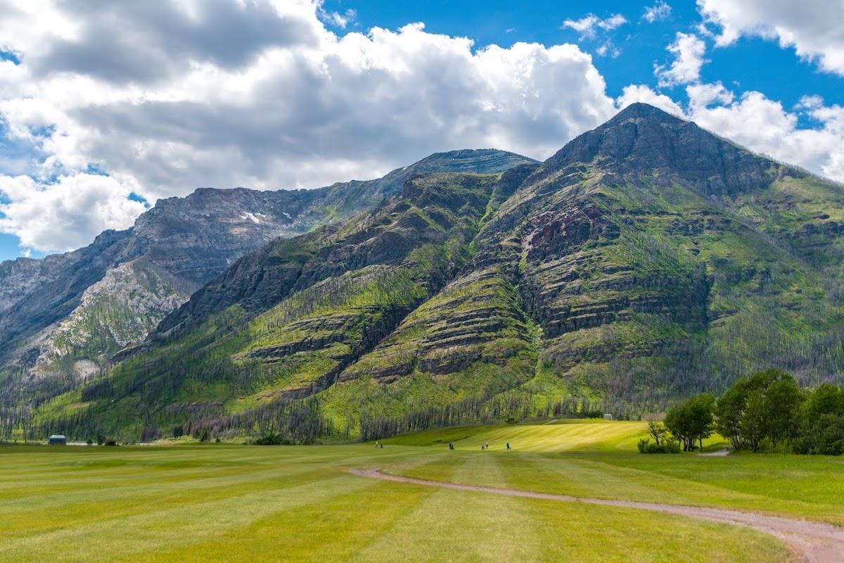 Golfing in front of Mount Crandell.