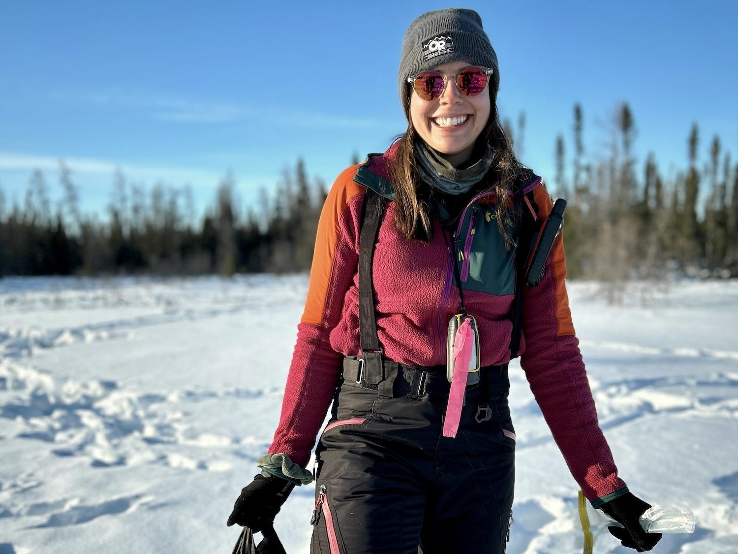 Joanne Kennah of the Government of Manitoba is shown in or near Wapusk National Park with a shopping bag full of caribou scat samples.