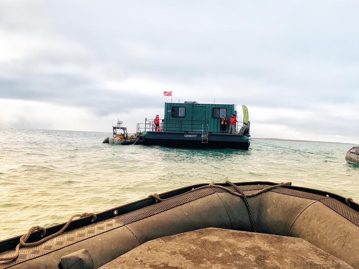 Taking a Zodiac to the diving barge studying the wreck of the HMS Erebus.