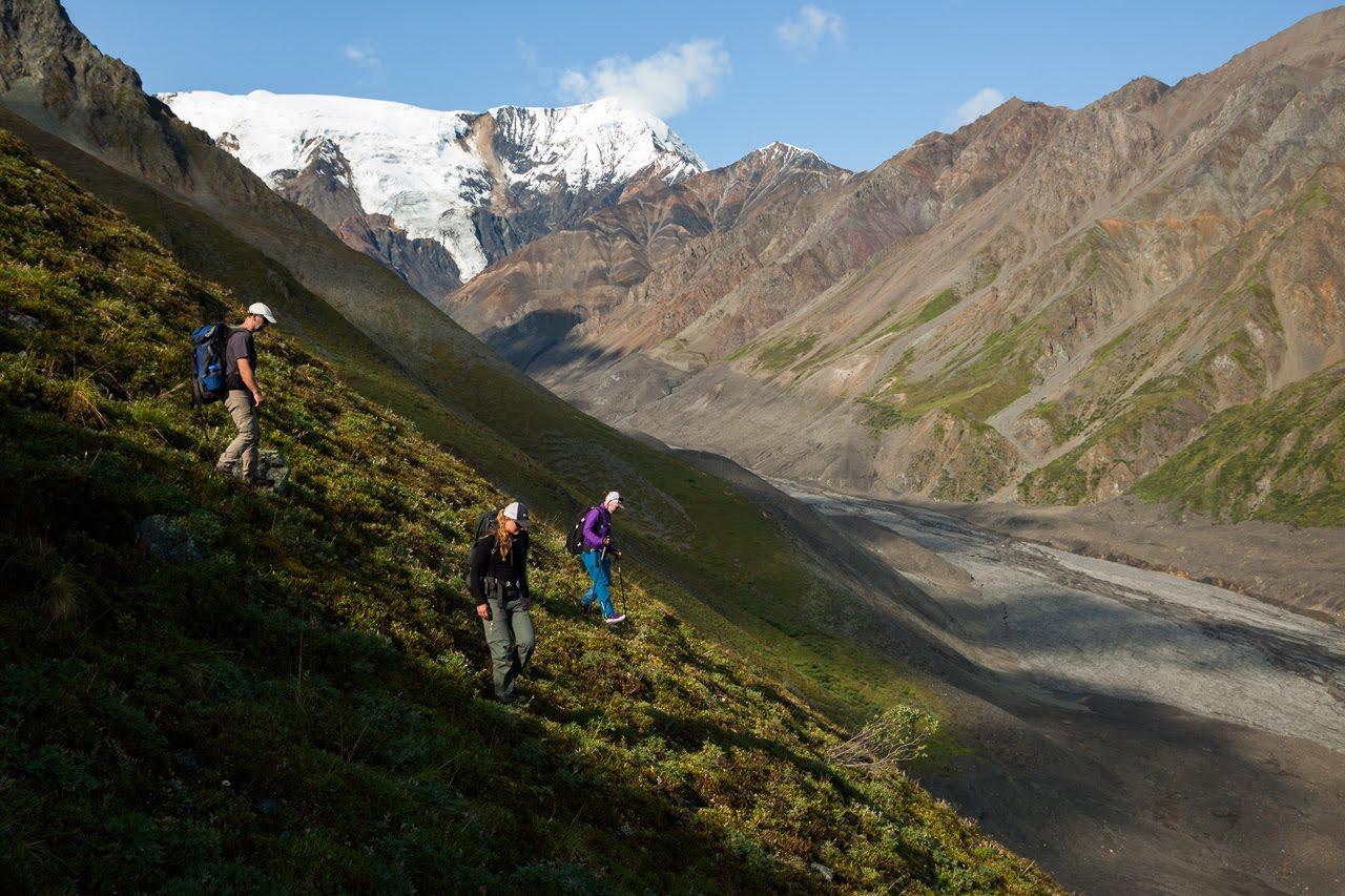 Matthias Leopold, Lia Lajoie, and Mylène Jacquemart (l-r) hike from their camp (located out of harms way, far above the valley) down to the deposits left by the Flat Creek glacier detachments along the valley bottom. The start of a nine hour day in the fi