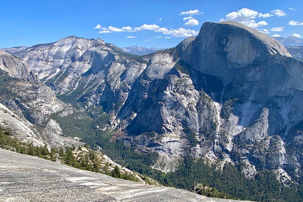 A 2022 view of Tenaya Canyon as seen from North Dome, with Half Dome on the right. Half Dome was sheared off as the canyon deepened over the last 5 million years. (Photo credit: Kurt Cuffey)