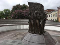 A stone and metal memorial of African-American soldiers holding Civil War muskets, African American Civil War Memorial