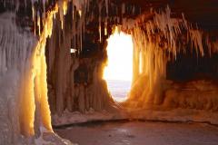 Bright sunlight shining onto the ice through an ice cave opening in Apostle Islands National Lakeshore