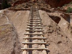 The leading line of a wooden ladder leading up to the ruins in Bandelier National Monument