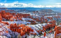 Sunshine, clouds, and spring snow on the red rock hoodoos of Bryce Canyon National Park, Utah