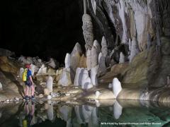 A caver looking at the stalactites and stalagmites within Lechuguilla Cave at Carlsbad Caverns National Park