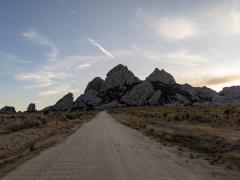 A leading line of a dirt road heading toward a cluster of tall rocks in the City of Rocks National Reserve in Idaho