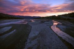Sunrises soften the ruggedness of Denali National Park's Teklankia River.