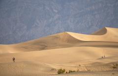 Two people exploring the environment at Mesquite Flat Sand Dunes, Death Valley National Park